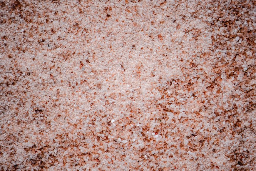 Close up of pink, coarse grains of Himalayan salt