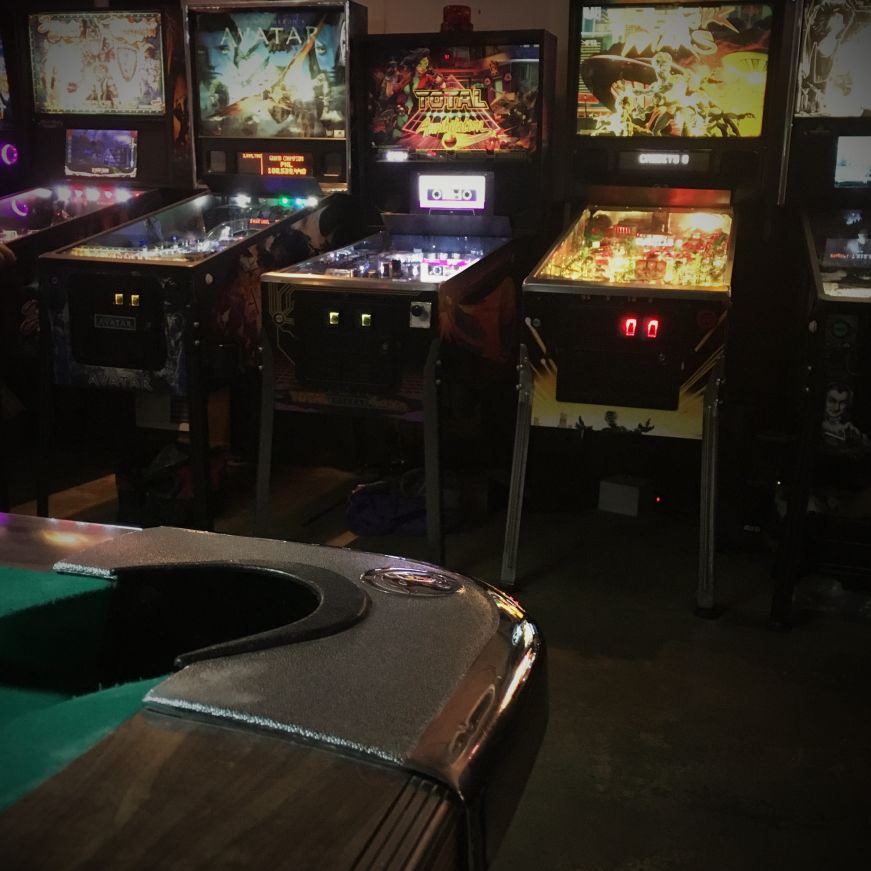 Row of pinball machines with corner of pool table in the foreground, 403 Club, Kansas City, Kansas