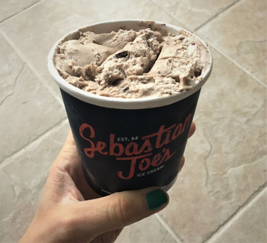 Hand holding pint of Oreo ice cream 