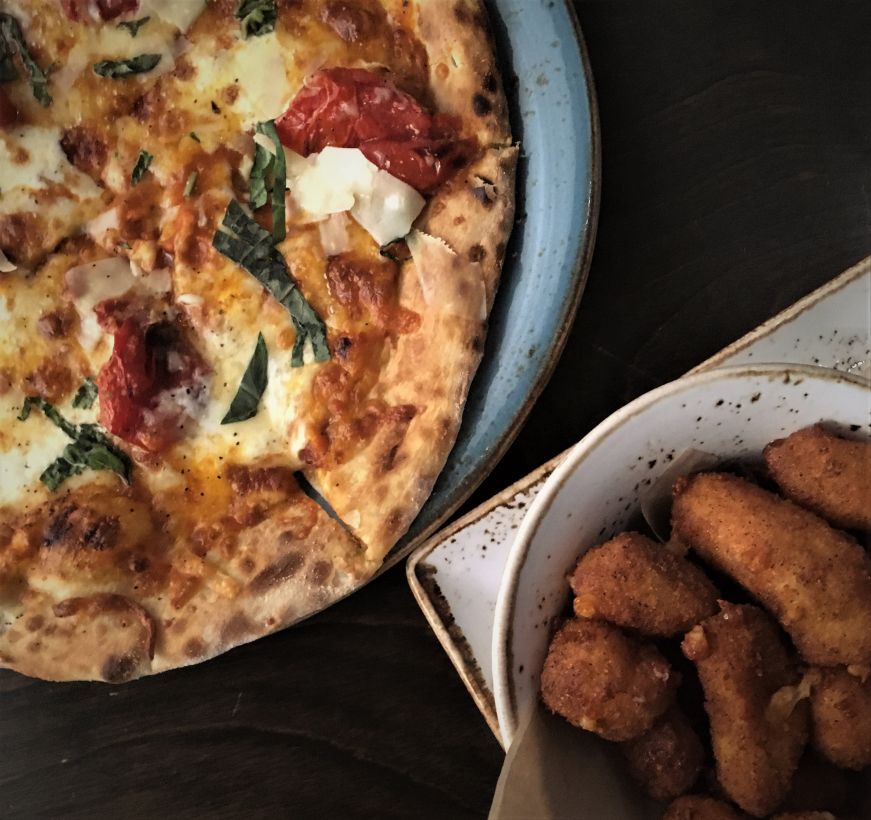 Top down view of pizza and cheese curds on a wooden table, Cedar + Stone Urban Table, Mall of America