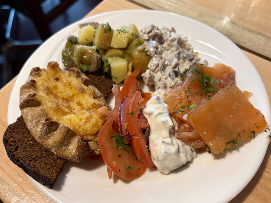 Plate of salads, cured fish, and breads
