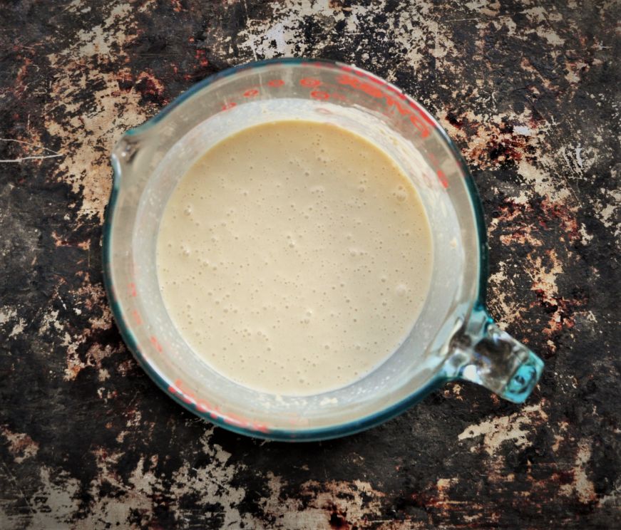 Popover batter in a clear bowl with a handle and spout