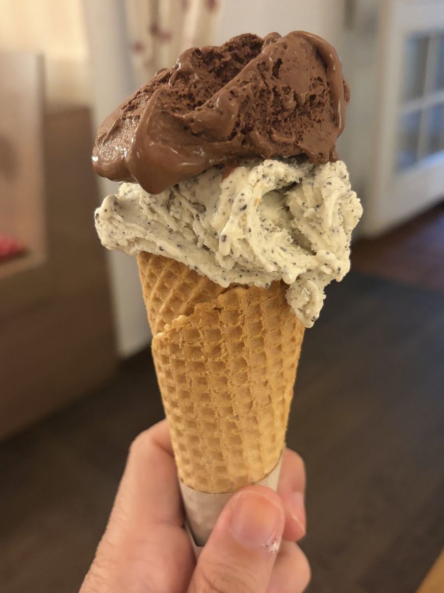 Ice cream cone with a scoop of poppy seed and a scoop of chocolate ice cream