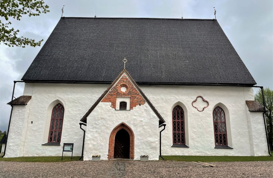 Simple white church with a high slanted black roof