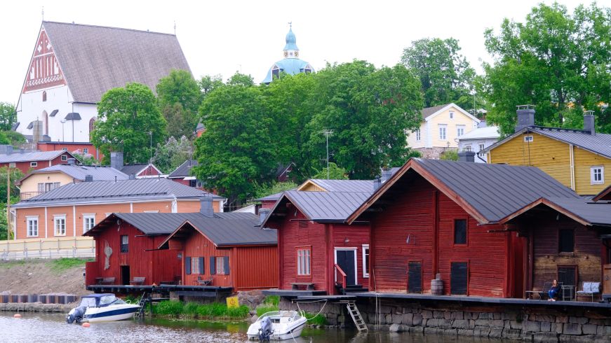 Riverfront lined with red wooden buildings