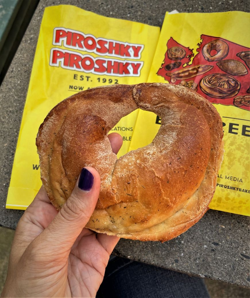 Hand holding crescent-shaped filled bread