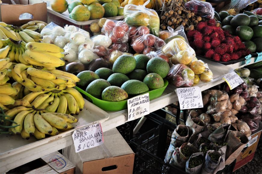 Piles of apple bananas, avocados, and passion fruit at Hilo Farmer's Market, Hawaii