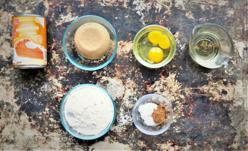 Pumpkin muffins ingredients arranged on a baking sheet