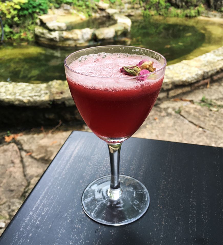 Purple Rose of Cairo, the Velveteen, Stillwater Purple cocktail garnished with a dried rose