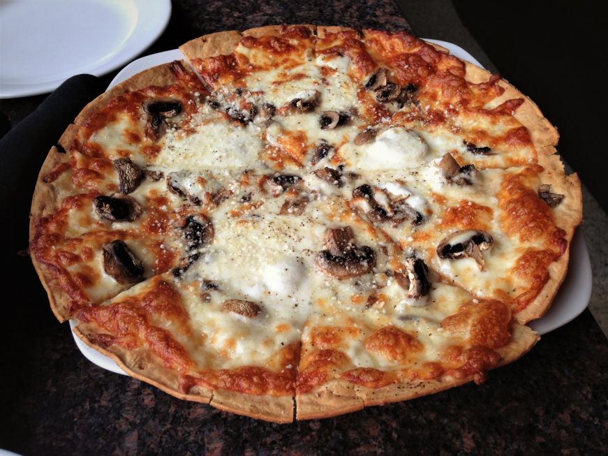 Neapolitan-style pizza topped with mushrooms and cheese