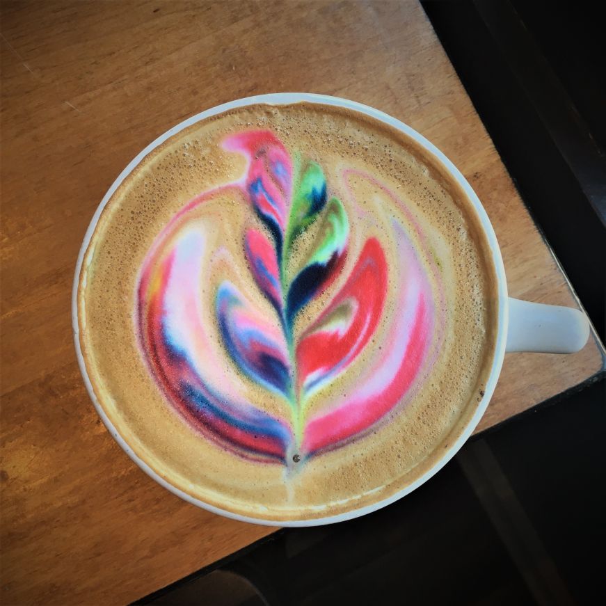 Latte with elaborate rainbow latte art