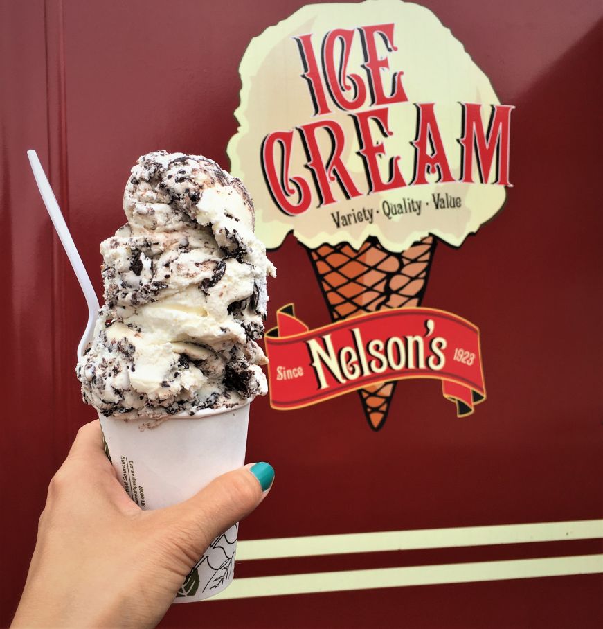 Child size cup, Nelson's Ice Cream Hand holding cup heaped with scoops of ice cream