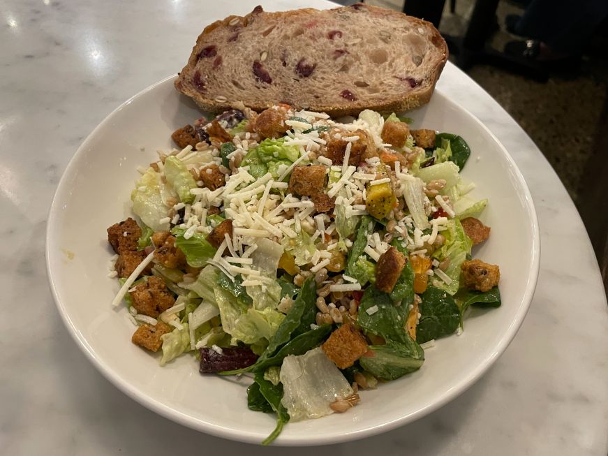 Roasted heirloom carrot and farro salad at Flour Bakery & Cafe Roasted heirloom carrot and farro salad with a piece of cranberry bread on the side