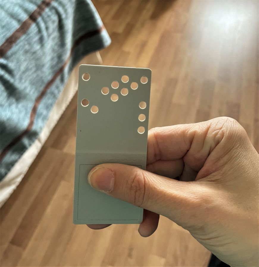 Room key at Hotelli Tallukka Hand holding room key with several round holes