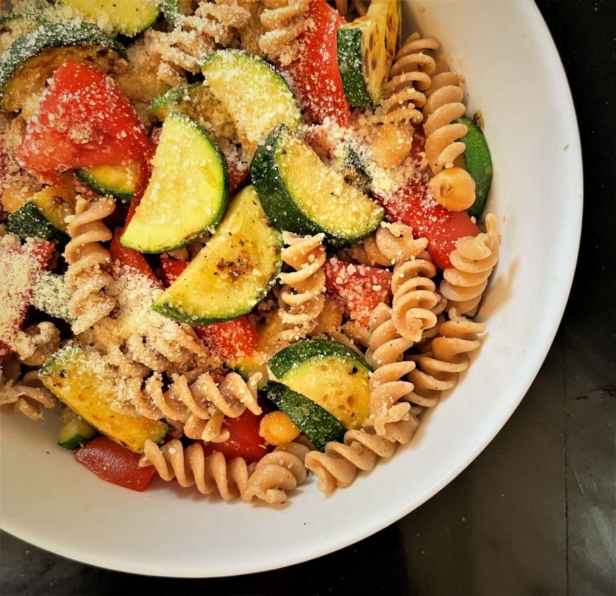 Bowl of rotini pasta with zucchini and tomatoes