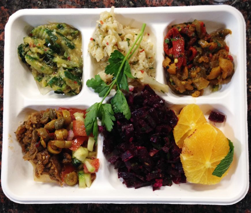 Cafeteria-style tray with several vegetarian salads