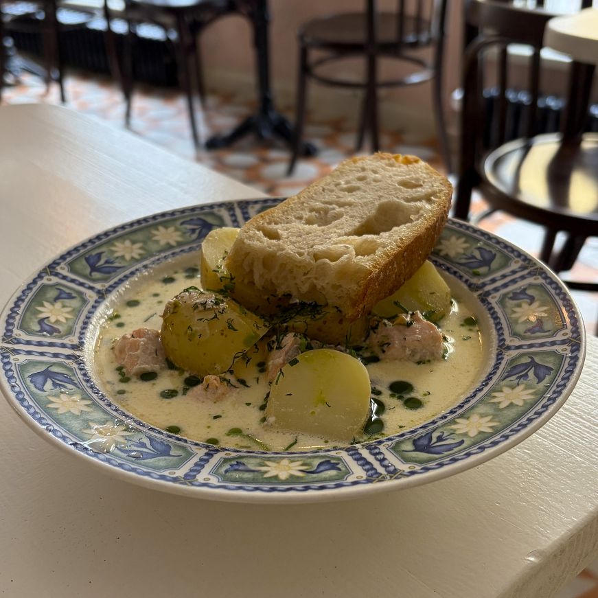 Bowl of salmon soup and slice of focaccia