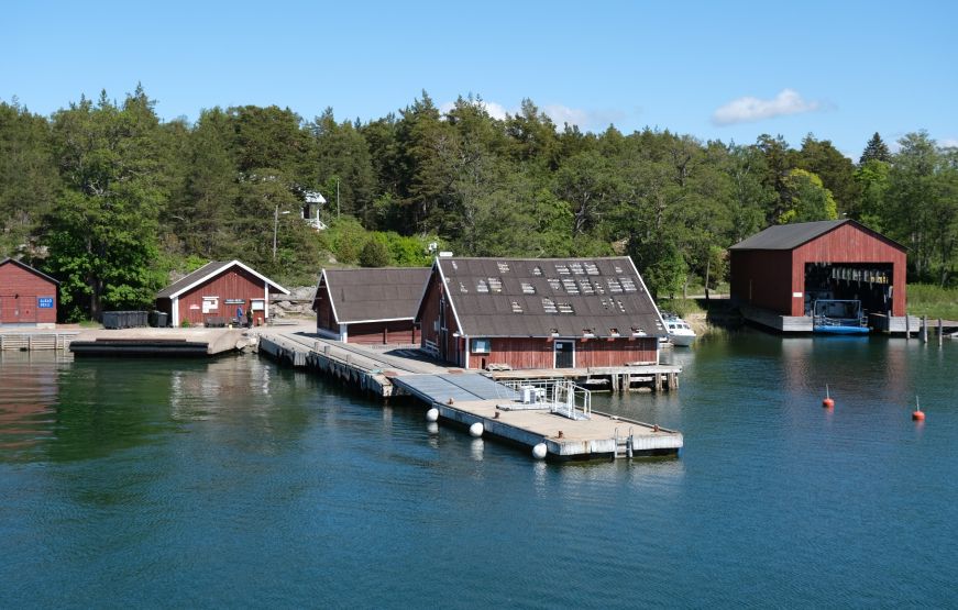 Red wooden buildings and a pier