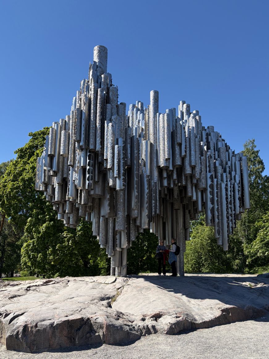 Abstract sculpture consisting of hundreds of large silver metal tubes