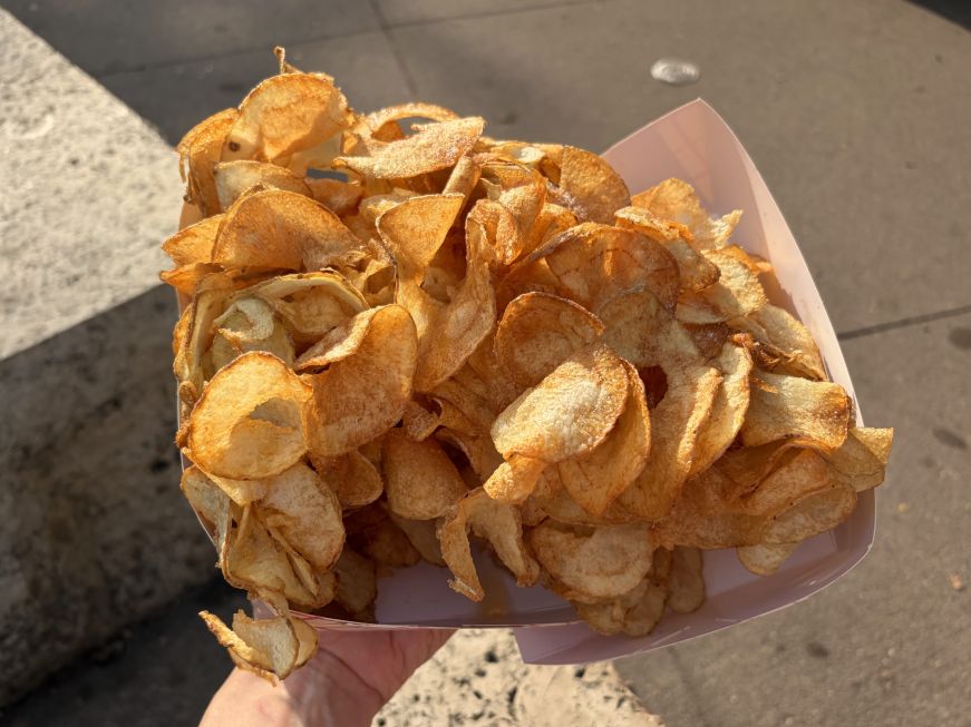 Pile of deep-fried spiral cut potatoes in two cardboard boats
