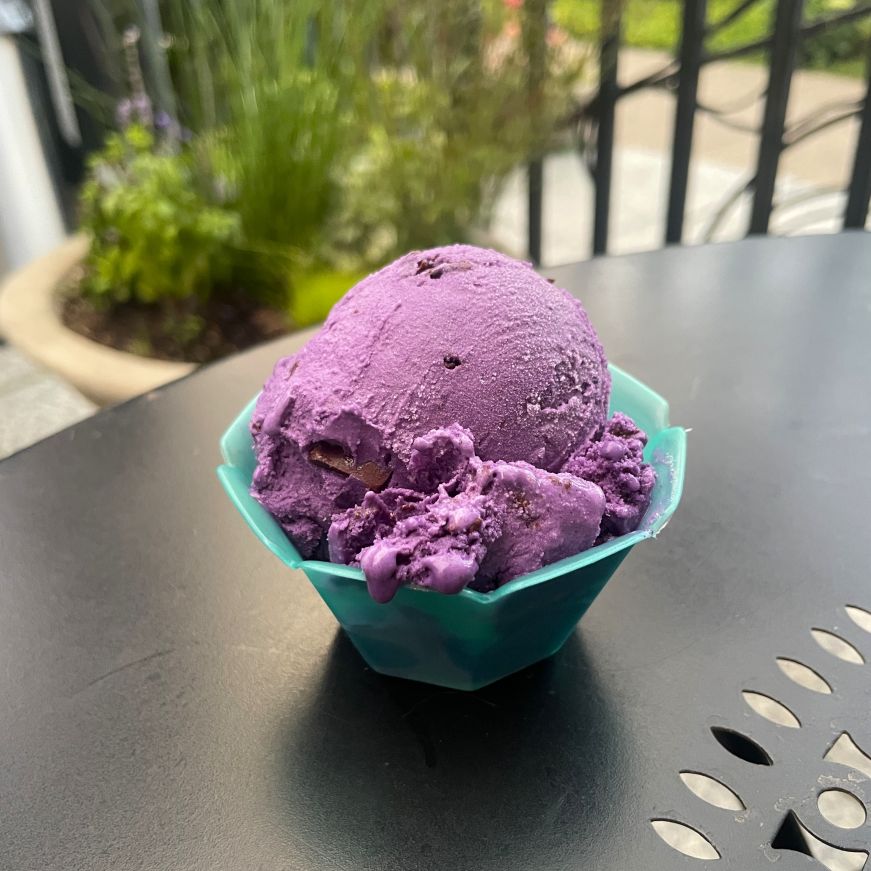 Ube straciatella gelato, Sonny's Ice Cream Cafe Cup of bright purple gelato on a bistro table