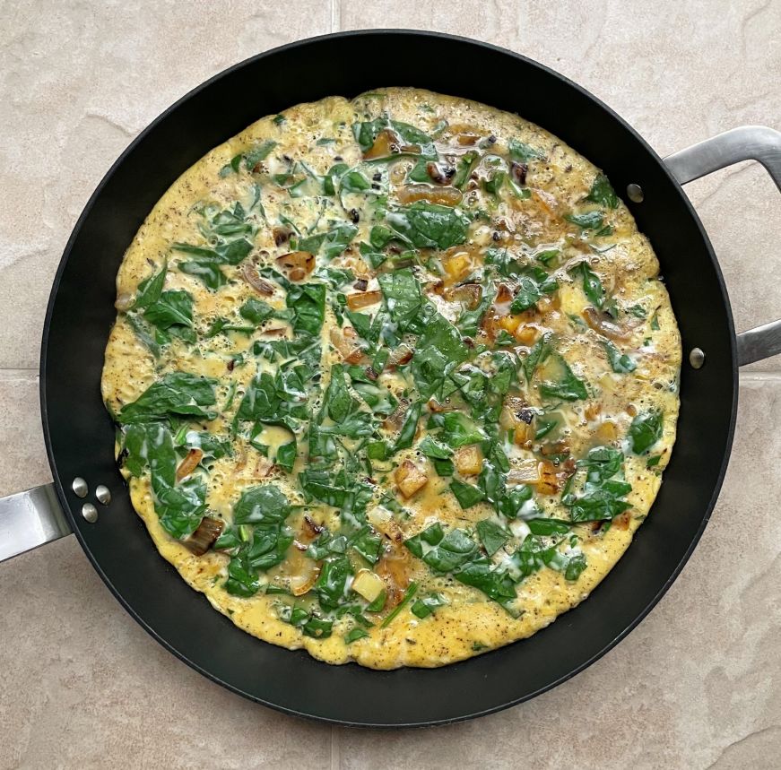 Skillet with tortilla before flipping