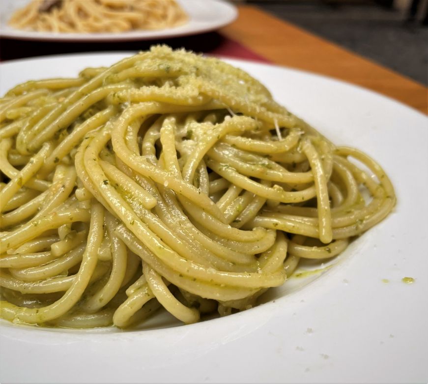 Plate of spaghetti tossed with basil pesto