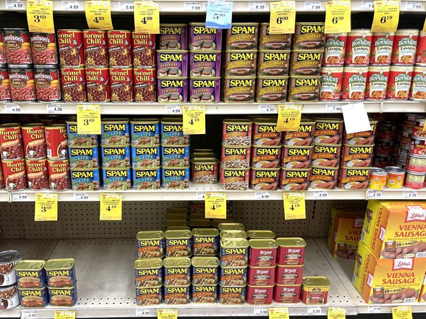 Grocery store shelves stocked with a variety of Spam flavors