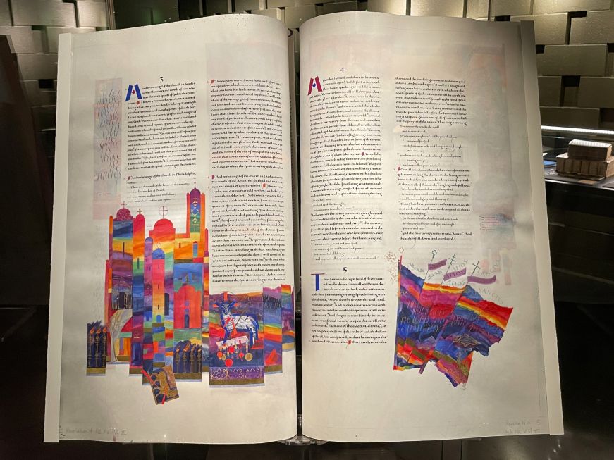 Large illuminated Bible pages with colorful artwork
