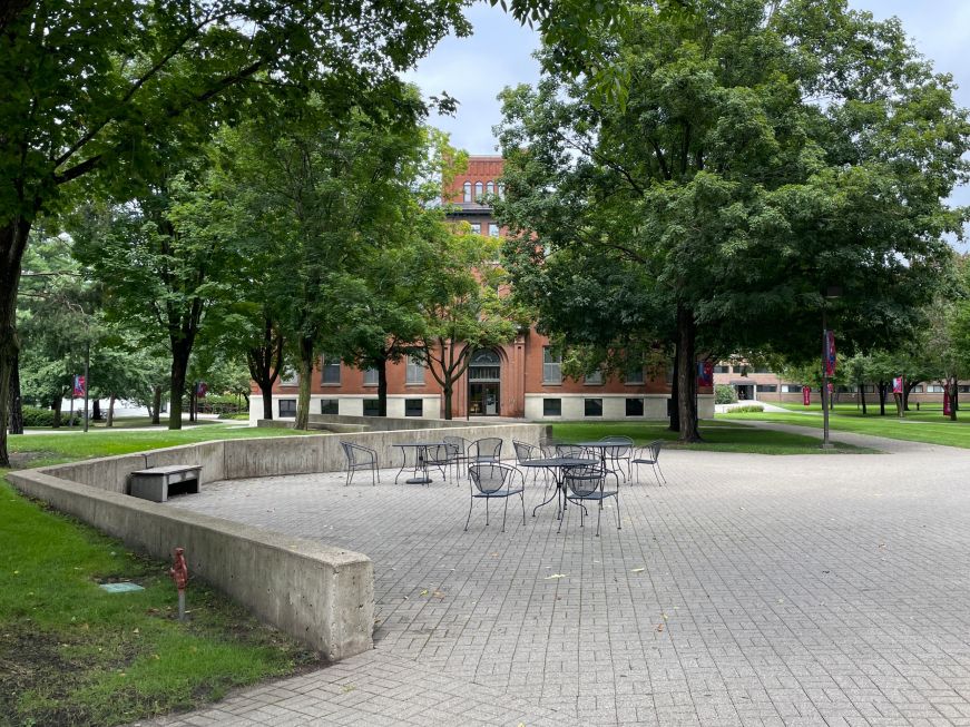 Plaza surrounded by trees and brick buildings