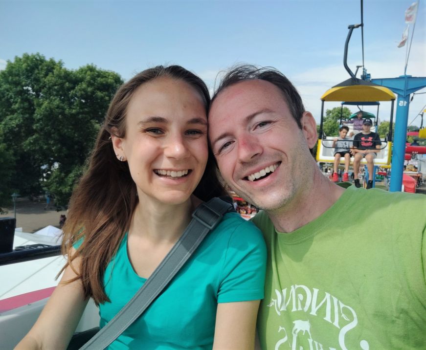 Stacy and Mike sitting in a chair-lift style seat