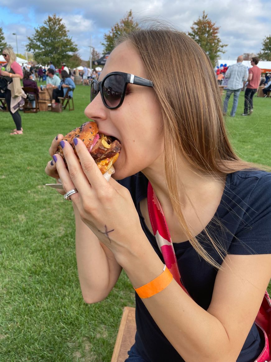 Stacy eating a barbecue sandwich
