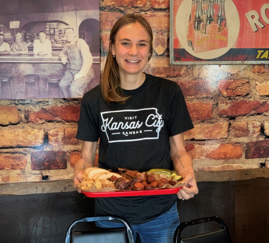 Stacy holding a tray of barbecue meat and sides at Rosedale Bar-B-Que, Kansas City, Kansas