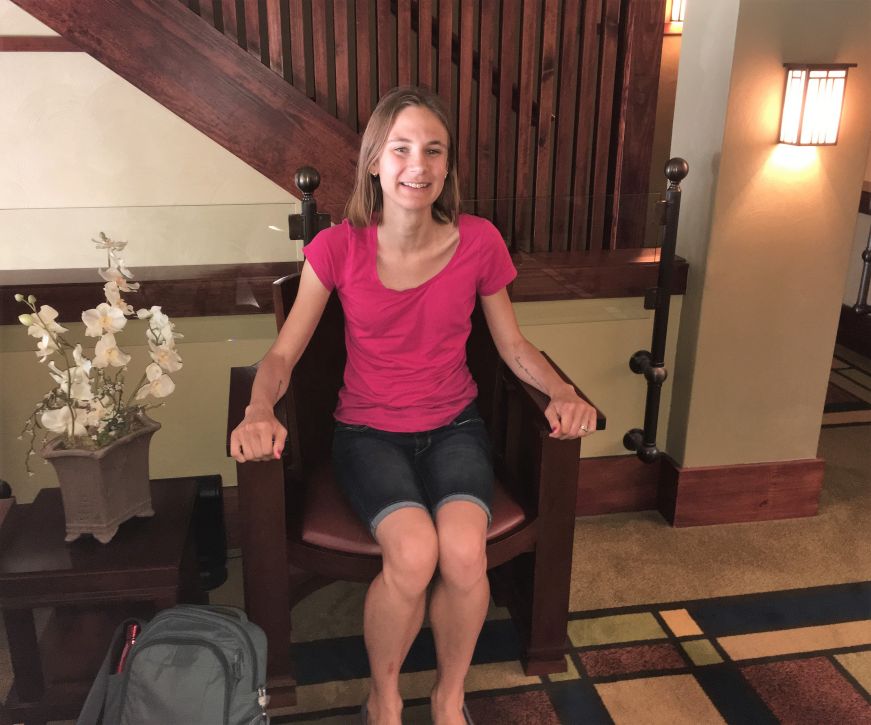 Stacy sitting in Frank Lloyd Wright chair, Historic Park Inn, Mason City