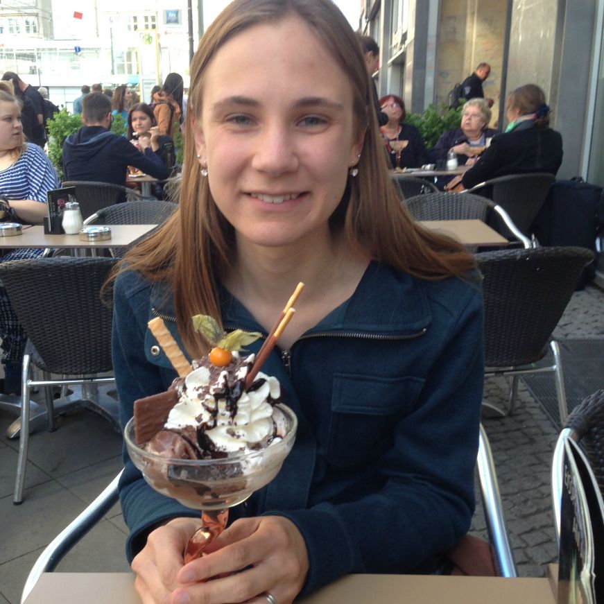 Stacy with a sundae at a sidewalk cafe in Germany