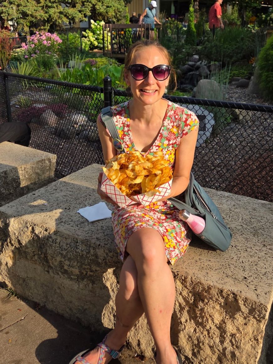 Stacy holding a large serving of potato chips