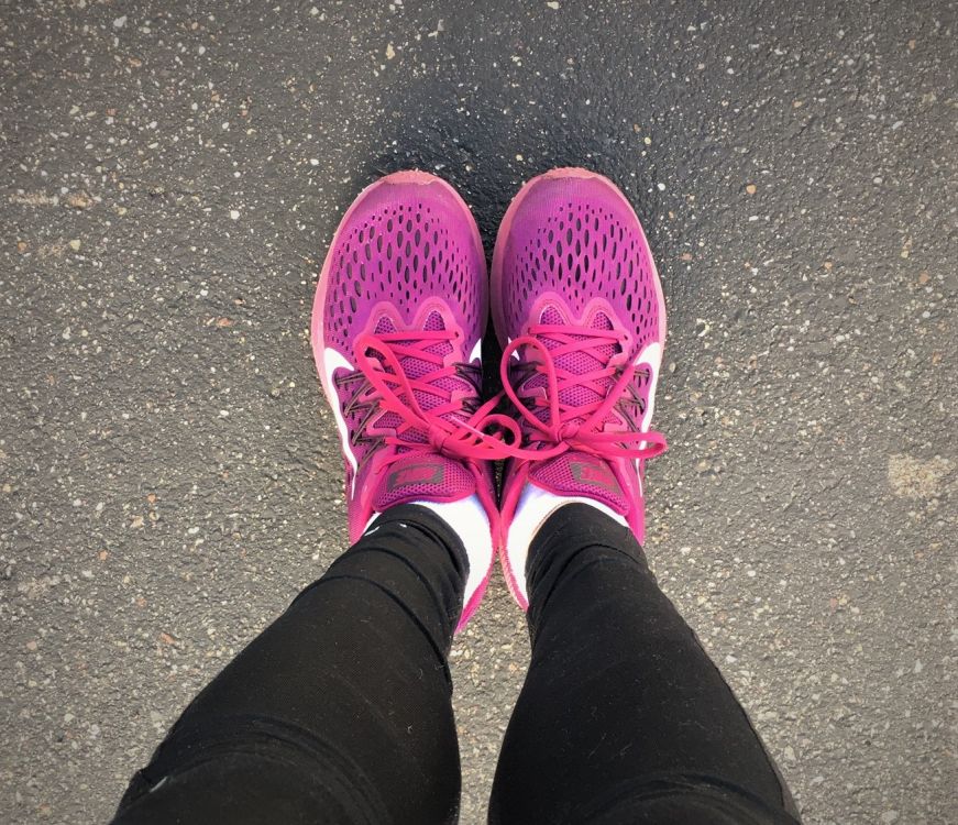 Stacy's feet in magenta running shoes