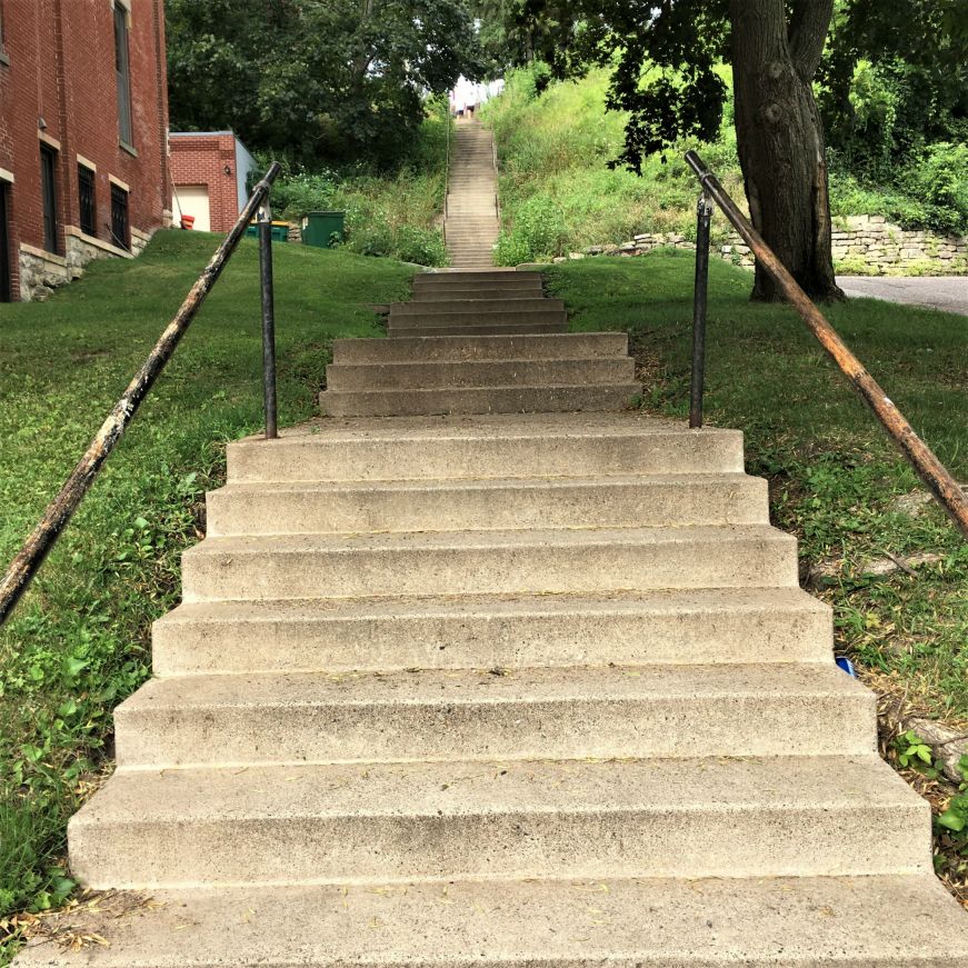 Cement staircase leading up a very steep hill