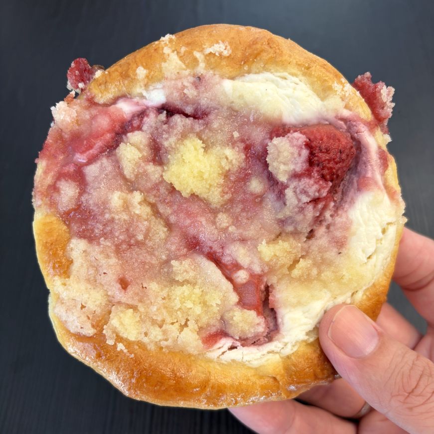 Kolache topped with cream cheese, strawberries, rhubarb, and struesel