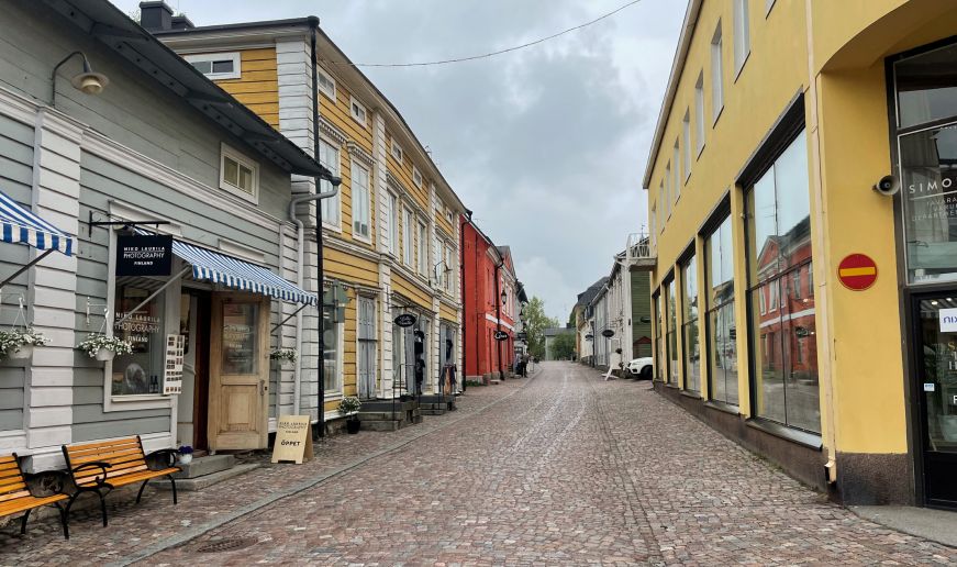 Street of colorful wooden shops along a cobblestone street