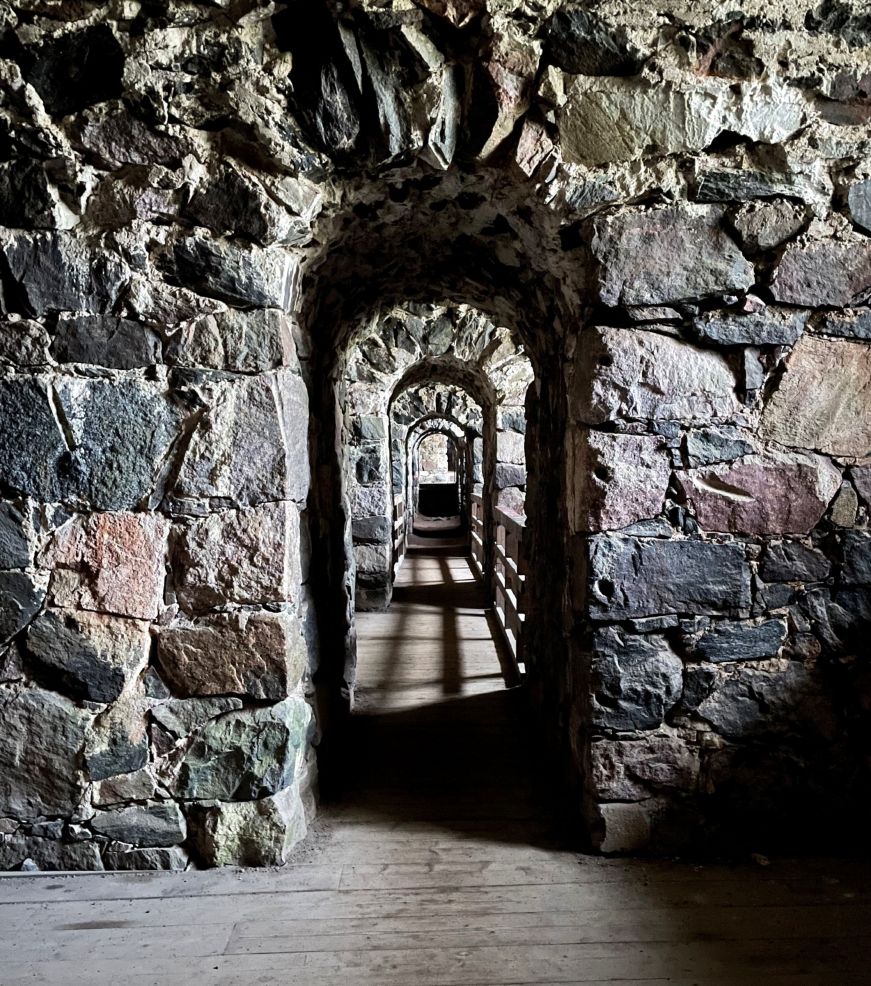 View through a series of portals in a hallway made from stone