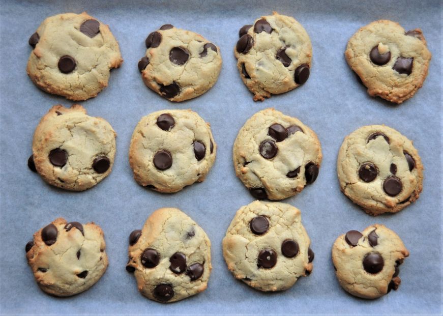 Tahini chocolate chip cookies on a parchment-lined baking sheet