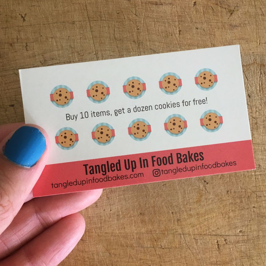Hand holding a business card with 10 small cookie icons