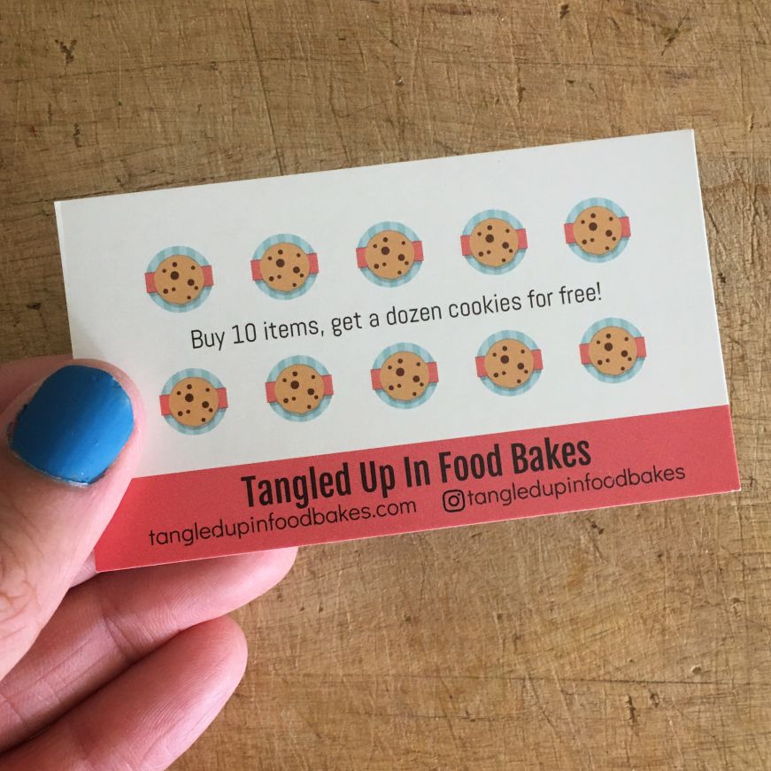 Tangled Up In Food Bakes loyalty card Hand holding a business card with 10 small cookie icons