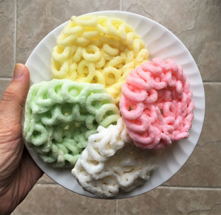 Brightly colored tapioca crackers on a white plate