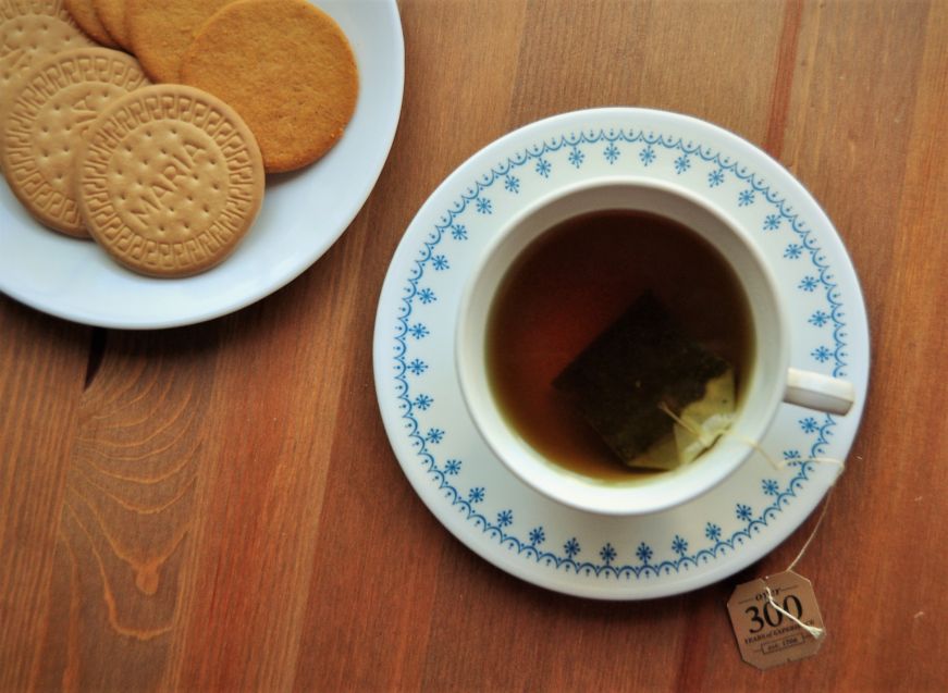 Tea cup with plate of cookies