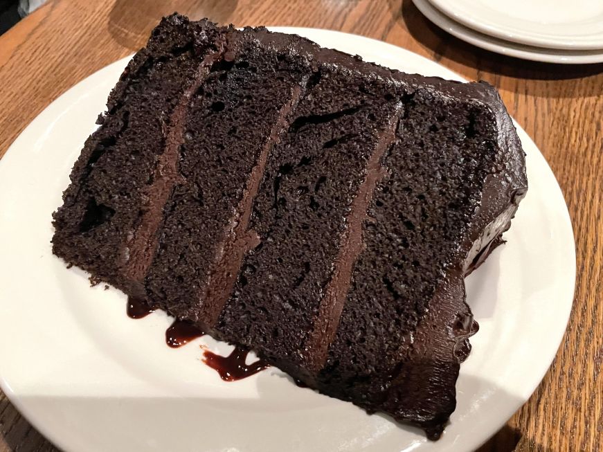 Towering Chocolate Cake for Two, Chanhassen Dinner Theatres Large wedge of chocolate layer cake