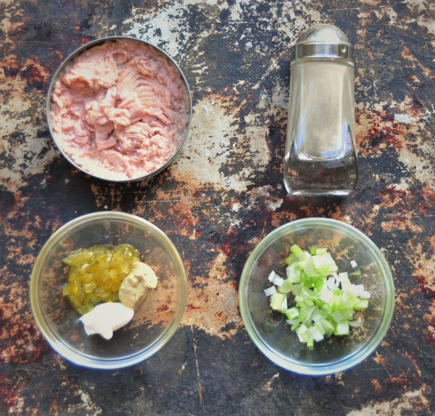 Top down view of tuna salad ingredients arranged on baking sheet