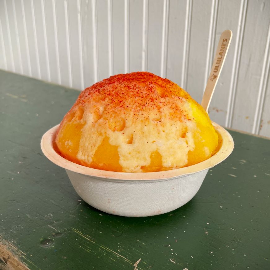 Cup of shave ice topped with li hing mui powder