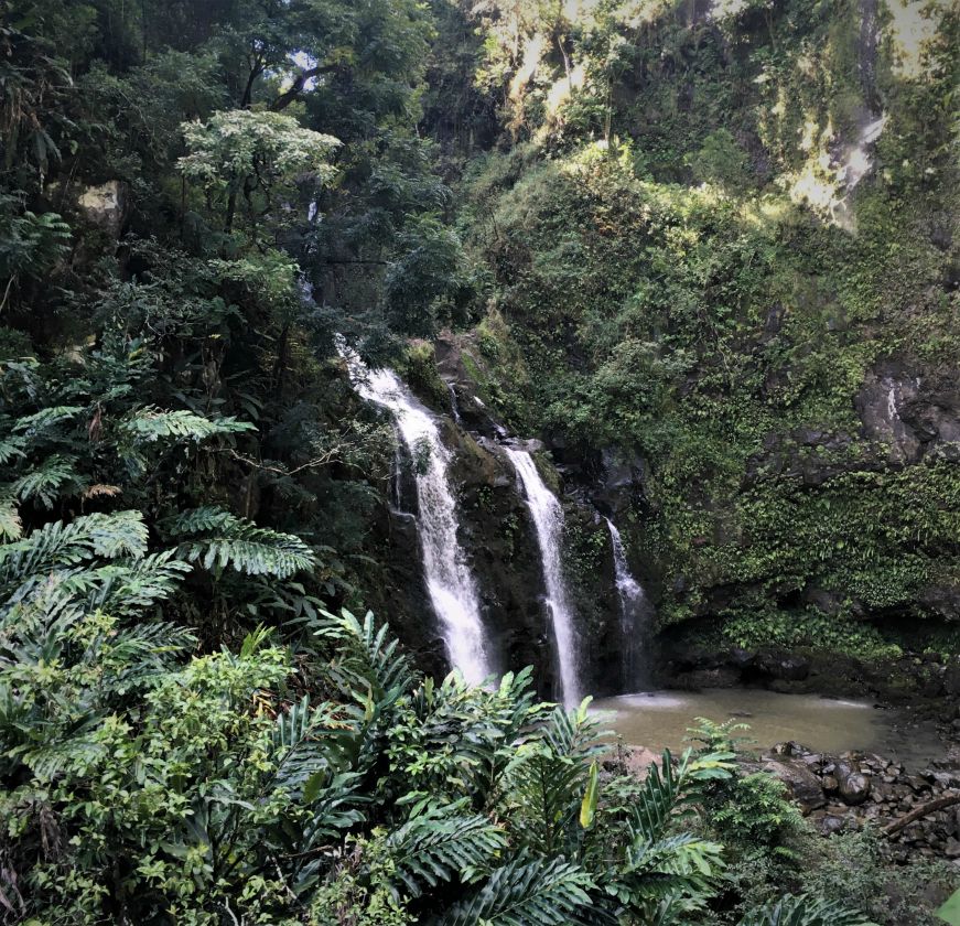 Three waterfalls in a row in a lush rainforest